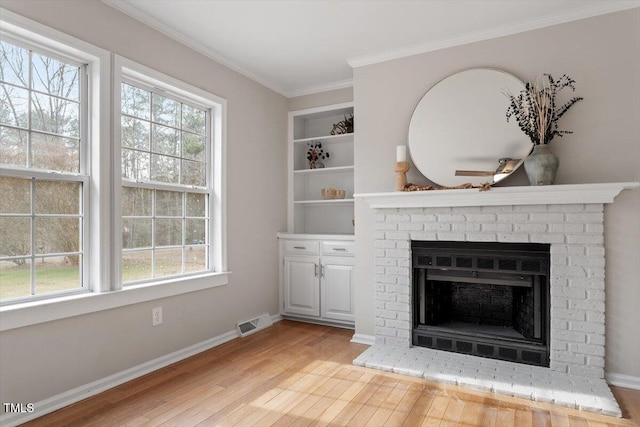 4720 Brigadoon Dr, Durham, NC 27705 - unfurnished living room with a fireplace, light wood-style flooring, plenty of natural light, crown molding, and baseboards
