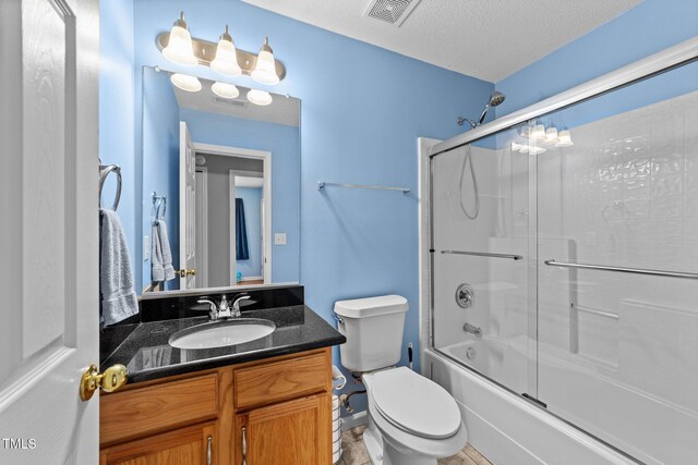4221 Ivy Hill Rd, Raleigh, NC 27616 - bathroom featuring vanity, combined bath / shower with glass door, toilet, and a textured ceiling