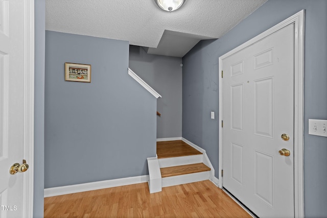 4221 Ivy Hill Rd, Raleigh, NC 27616 - foyer featuring stairway, a textured ceiling, wood finished floors, and baseboards