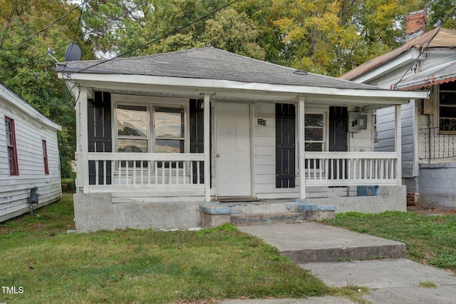230 Park Ave, Rocky Mount, NC 27801 - shotgun-style home with a porch, roof with shingles, and a front yard