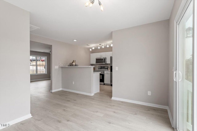 197 Scranton Ct, Cameron, NC 28326 - kitchen featuring appliances with stainless steel finishes, white cabinetry, light wood-style floors, and baseboards