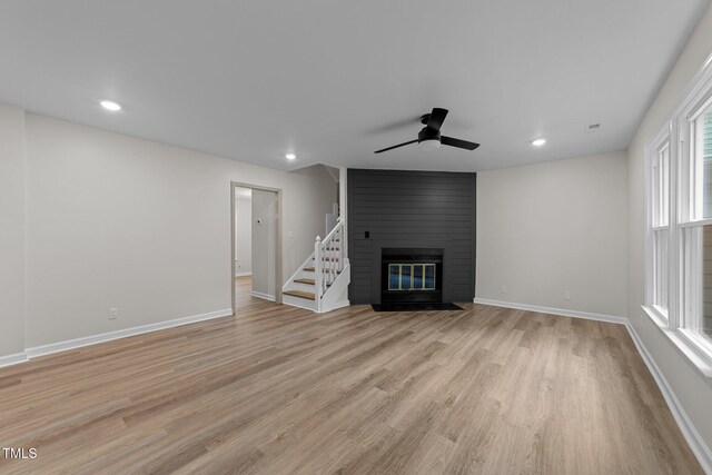 708 Powell Dr Unit B, Raleigh, NC 27606 - unfurnished living room featuring light wood finished floors, ceiling fan, baseboards, a large fireplace, and recessed lighting