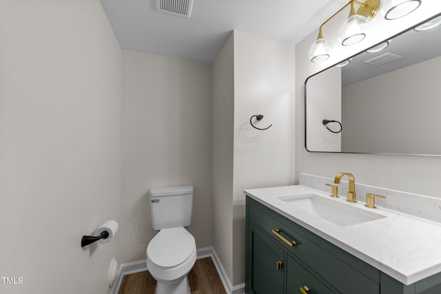 708 Powell Dr Unit B, Raleigh, NC 27606 - half bath with wood finished floors, toilet, vanity, and baseboards