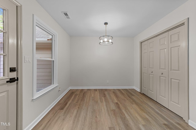 708 Powell Dr Unit B, Raleigh, NC 27606 - unfurnished dining area with light wood-style floors and baseboards