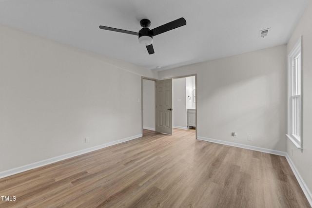 708 Powell Dr Unit B, Raleigh, NC 27606 - unfurnished bedroom featuring light wood finished floors, baseboards, a ceiling fan, and connected bathroom