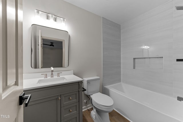 708 Powell Dr Unit B, Raleigh, NC 27606 - bathroom with toilet, wood finished floors, vanity, and bathing tub / shower combination