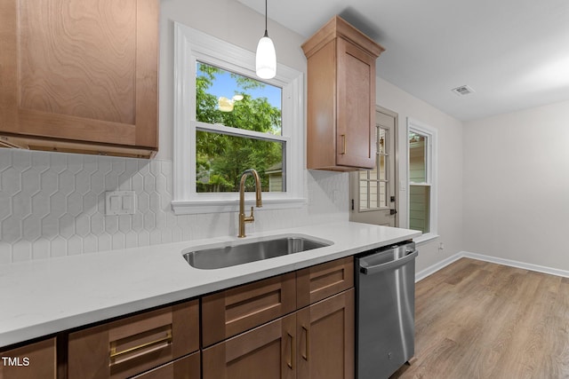 708 Powell Dr Unit B, Raleigh, NC 27606 - kitchen with dishwasher, a sink, light countertops, tasteful backsplash, and baseboards