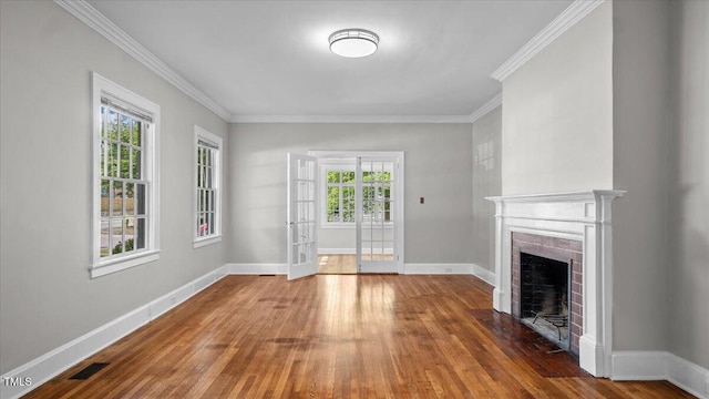 830 S Chestnut St, Henderson, NC 27536 - unfurnished living room featuring wood finished floors, a fireplace with flush hearth, ornamental molding, baseboards, and french doors