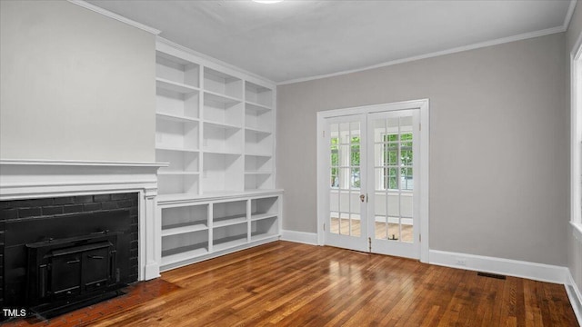 830 S Chestnut St, Henderson, NC 27536 - unfurnished living room with crown molding, wood finished floors, baseboards, and built in features