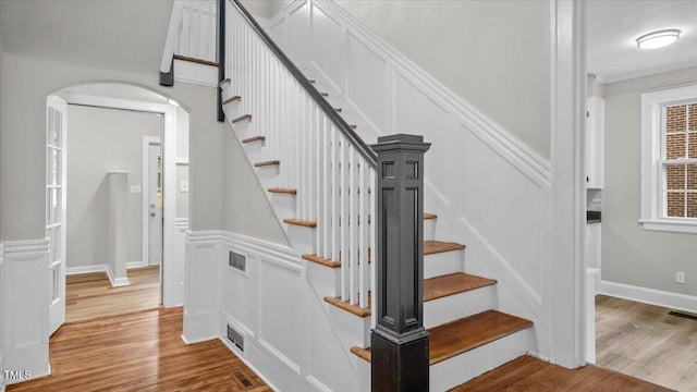 830 S Chestnut St, Henderson, NC 27536 - stairway featuring arched walkways, wood finished floors, and a decorative wall