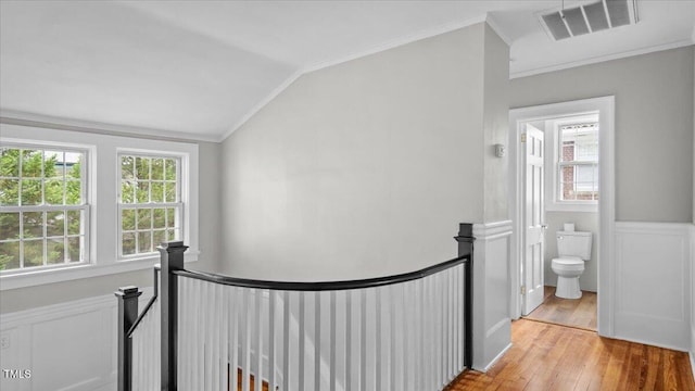 830 S Chestnut St, Henderson, NC 27536 - corridor featuring an upstairs landing, vaulted ceiling, light wood-type flooring, crown molding, and a wainscoted wall