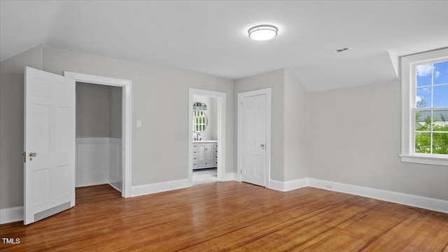 830 S Chestnut St, Henderson, NC 27536 - unfurnished bedroom featuring light wood finished floors, a closet, baseboards, and ensuite bath