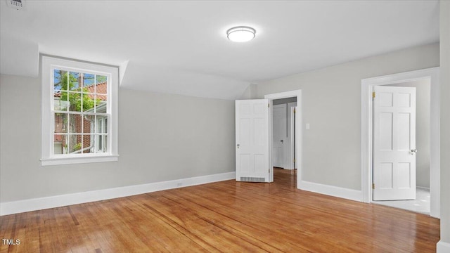 830 S Chestnut St, Henderson, NC 27536 - unfurnished bedroom with light wood-style flooring, baseboards, and vaulted ceiling