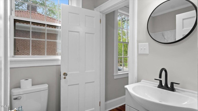 830 S Chestnut St, Henderson, NC 27536 - bathroom with vanity, toilet, and baseboards