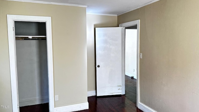 823 Dixon St, Kinston, NC 28501 - unfurnished bedroom featuring crown molding, dark wood finished floors, a closet, and baseboards