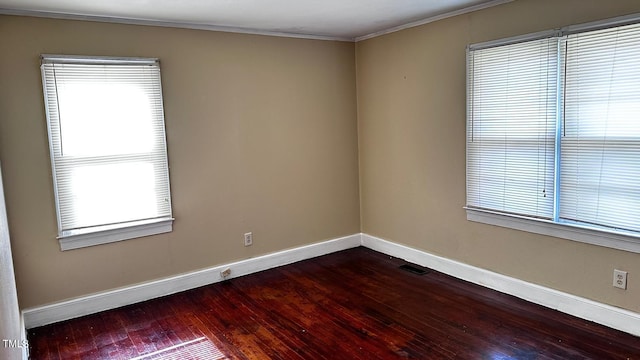 823 Dixon St, Kinston, NC 28501 - unfurnished room with baseboards, dark wood-type flooring, crown molding, and plenty of natural light