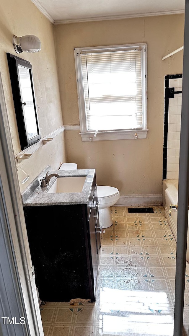 823 Dixon St, Kinston, NC 28501 - full bathroom featuring vanity, tile patterned floors, toilet, ornamental molding, and a tub to relax in