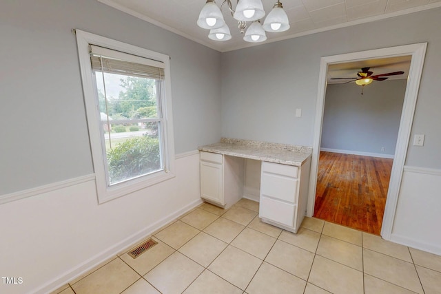 111 Dee Long Rd, Roxboro, NC 27574 - unfurnished office with ornamental molding, built in desk, light tile patterned flooring, and a chandelier