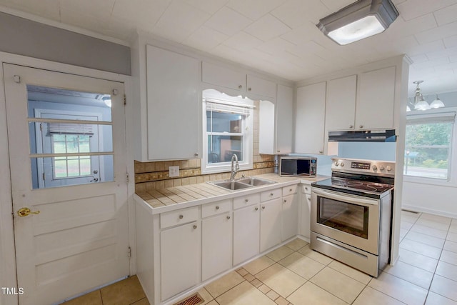 111 Dee Long Rd, Roxboro, NC 27574 - kitchen with stainless steel appliances, a sink, under cabinet range hood, white cabinetry, and light tile patterned flooring