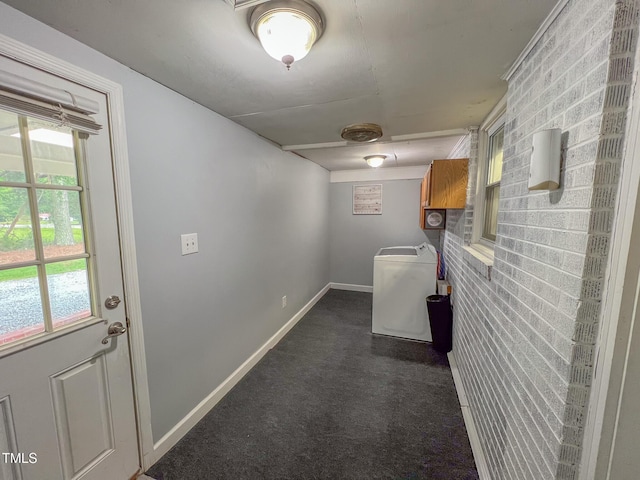 111 Dee Long Rd, Roxboro, NC 27574 - hallway with dark carpet, brick wall, baseboards, and washer / dryer