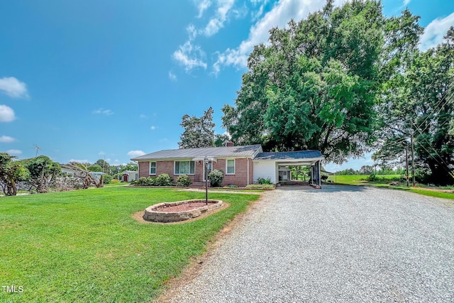 111 Dee Long Rd, Roxboro, NC 27574 - ranch-style house featuring gravel driveway, a carport, a front lawn, a chimney, and brick siding