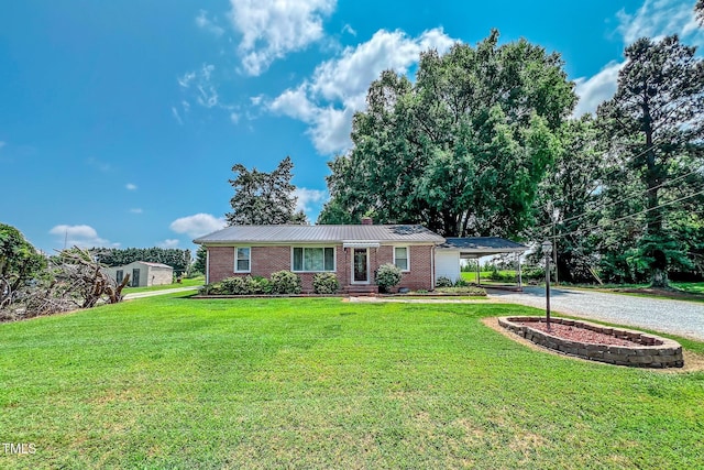 111 Dee Long Rd, Roxboro, NC 27574 - single story home featuring driveway, a front lawn, metal roof, brick siding, and an attached carport