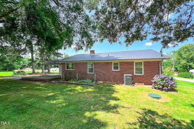 111 Dee Long Rd, Roxboro, NC 27574 - back of house with central AC, brick siding, a lawn, and metal roof