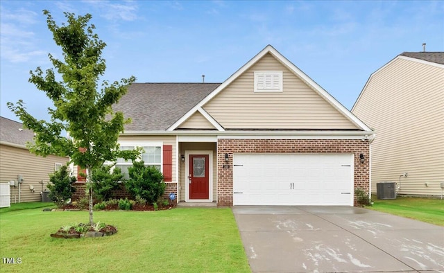 346 E Painted Way, Clayton, NC 27527 - traditional home featuring brick siding, concrete driveway, an attached garage, a front lawn, and roof with shingles
