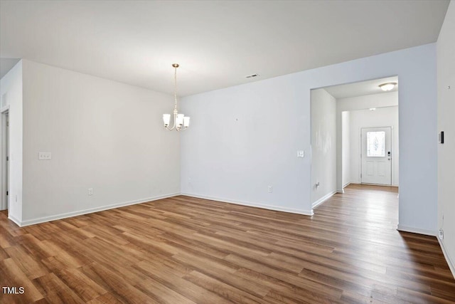 346 E Painted Way, Clayton, NC 27527 - spare room with a chandelier and wood finished floors
