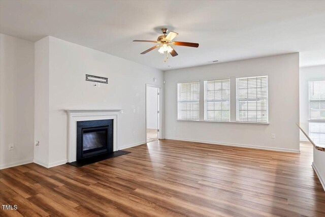 346 E Painted Way, Clayton, NC 27527 - unfurnished living room with a ceiling fan, a glass covered fireplace, and wood finished floors
