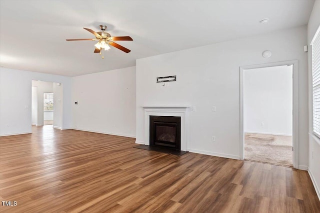 346 E Painted Way, Clayton, NC 27527 - unfurnished living room featuring ceiling fan, wood finished floors, and a glass covered fireplace
