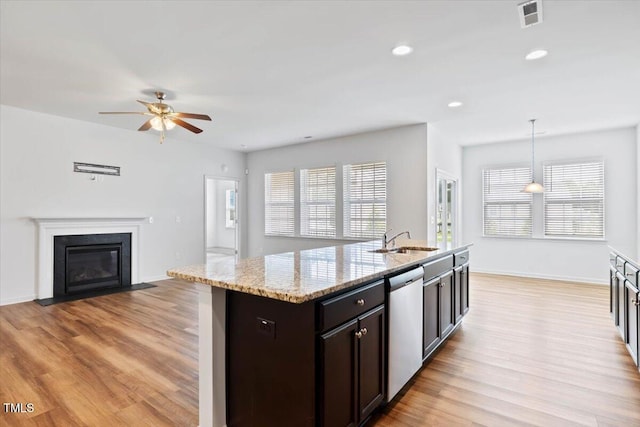 346 E Painted Way, Clayton, NC 27527 - kitchen with dishwasher, a ceiling fan, open floor plan, light wood-style floors, and light stone counters