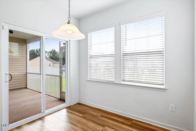 346 E Painted Way, Clayton, NC 27527 - unfurnished dining area featuring wood finished floors and baseboards