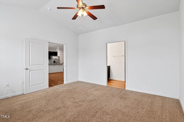 346 E Painted Way, Clayton, NC 27527 - unfurnished bedroom featuring carpet, stainless steel fridge with ice dispenser, lofted ceiling, and ensuite bath