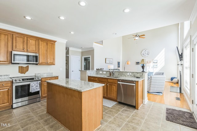 30155 Pharr, Chapel Hill, NC 27517 - kitchen featuring stainless steel appliances, a kitchen island with sink, a sink, light tile patterned flooring, and recessed lighting