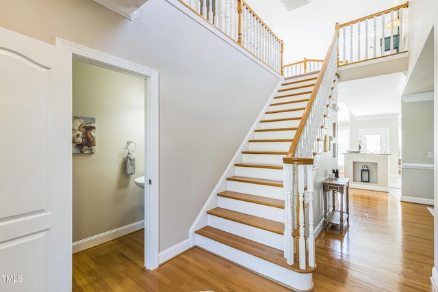 30155 Pharr, Chapel Hill, NC 27517 - stairs featuring wood finished floors, baseboards, crown molding, and a high ceiling