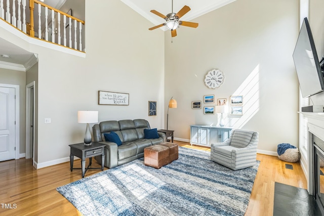 30155 Pharr, Chapel Hill, NC 27517 - living room featuring high vaulted ceiling, crown molding, baseboards, a fireplace with flush hearth, and a ceiling fan