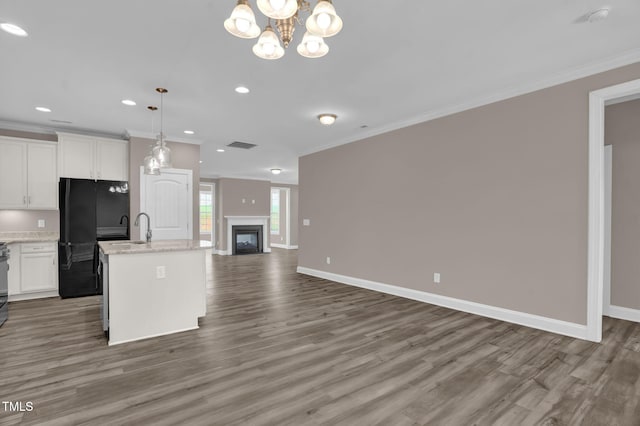 1085 Lobdale Ct, Burlington, NC 27215 - kitchen with open floor plan, freestanding refrigerator, crown molding, wood finished floors, and an island with sink
