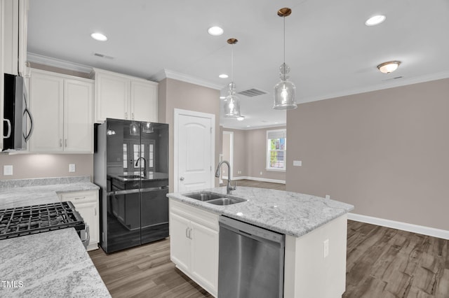 1085 Lobdale Ct, Burlington, NC 27215 - kitchen featuring appliances with stainless steel finishes, a sink, wood finished floors, a center island with sink, and ornamental molding