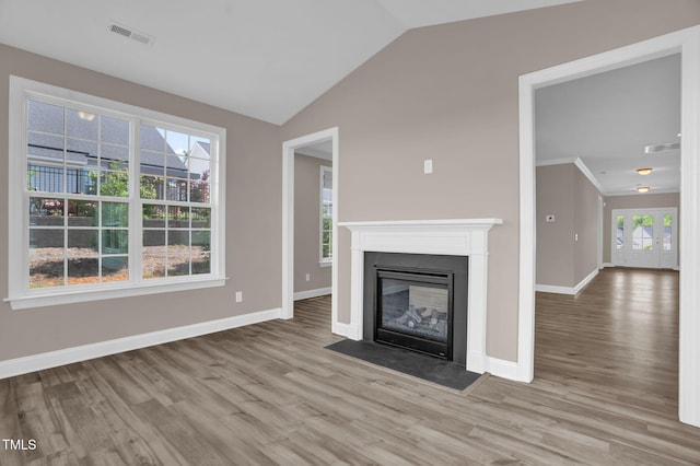 1085 Lobdale Ct, Burlington, NC 27215 - unfurnished living room featuring wood finished floors, lofted ceiling, baseboards, and a fireplace with flush hearth