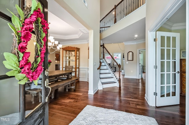 2100 Della Ct, Apex, NC 27502 - foyer featuring stairs, wood-type flooring, crown molding, a chandelier, and baseboards