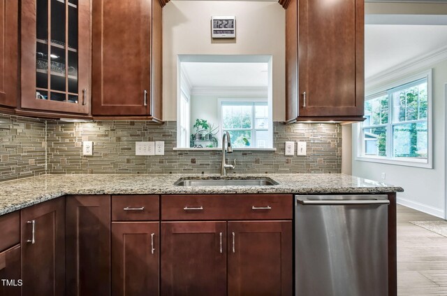 2100 Della Ct, Apex, NC 27502 - kitchen with stainless steel dishwasher, a sink, ornamental molding, decorative backsplash, and wood finished floors