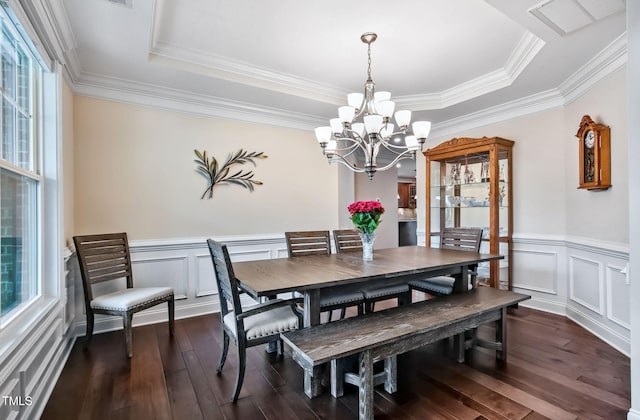 2100 Della Ct, Apex, NC 27502 - dining space with a chandelier, a tray ceiling, dark wood-style flooring, ornamental molding, and a wainscoted wall