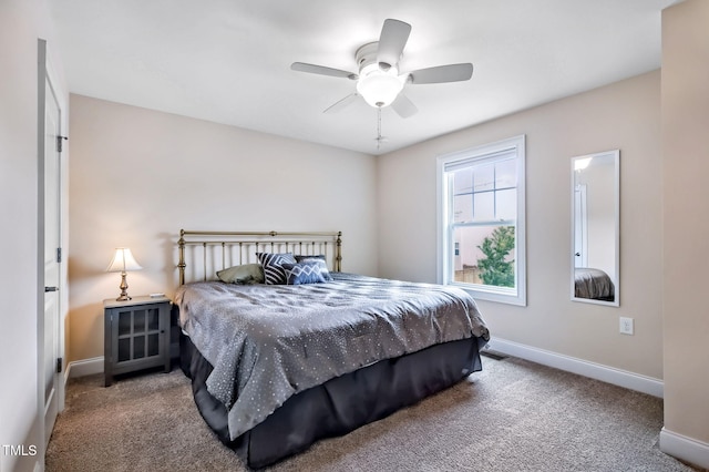 2100 Della Ct, Apex, NC 27502 - carpeted bedroom with baseboards and ceiling fan