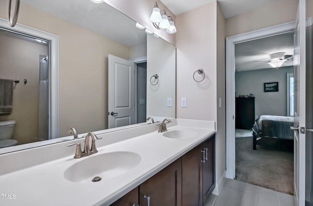 2100 Della Ct, Apex, NC 27502 - full bathroom with ensuite bath, double vanity, toilet, and tile patterned floors