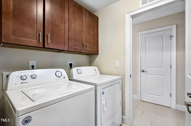 2100 Della Ct, Apex, NC 27502 - laundry room with cabinet space, washing machine and dryer, light tile patterned flooring, and baseboards