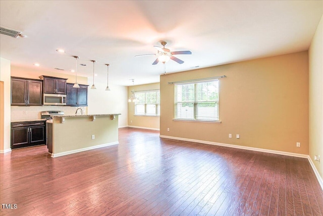 145 Torrey Heights Ln, Durham, NC 27703 - unfurnished living room with a ceiling fan, dark wood-style floors, baseboards, a sink, and recessed lighting