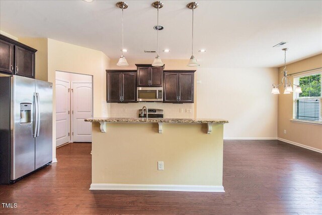 145 Torrey Heights Ln, Durham, NC 27703 - kitchen with stainless steel appliances, dark brown cabinets, dark wood finished floors, a breakfast bar area, and recessed lighting