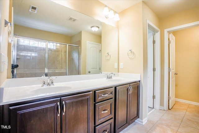 145 Torrey Heights Ln, Durham, NC 27703 - full bath featuring double vanity, tile patterned flooring, tiled shower, and baseboards