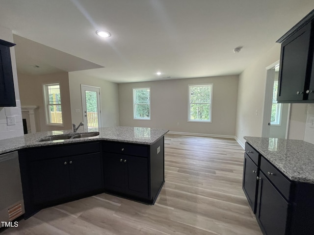 226 Bonsai Way, Four Oaks, NC 27524 - kitchen with dishwasher, light wood-type flooring, light stone countertops, dark cabinets, and recessed lighting